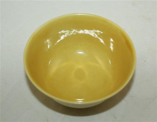 A Chinese yellow glazed small flared bowl, Kangxi six character mark and possibly of the period, diam. 9.5cm